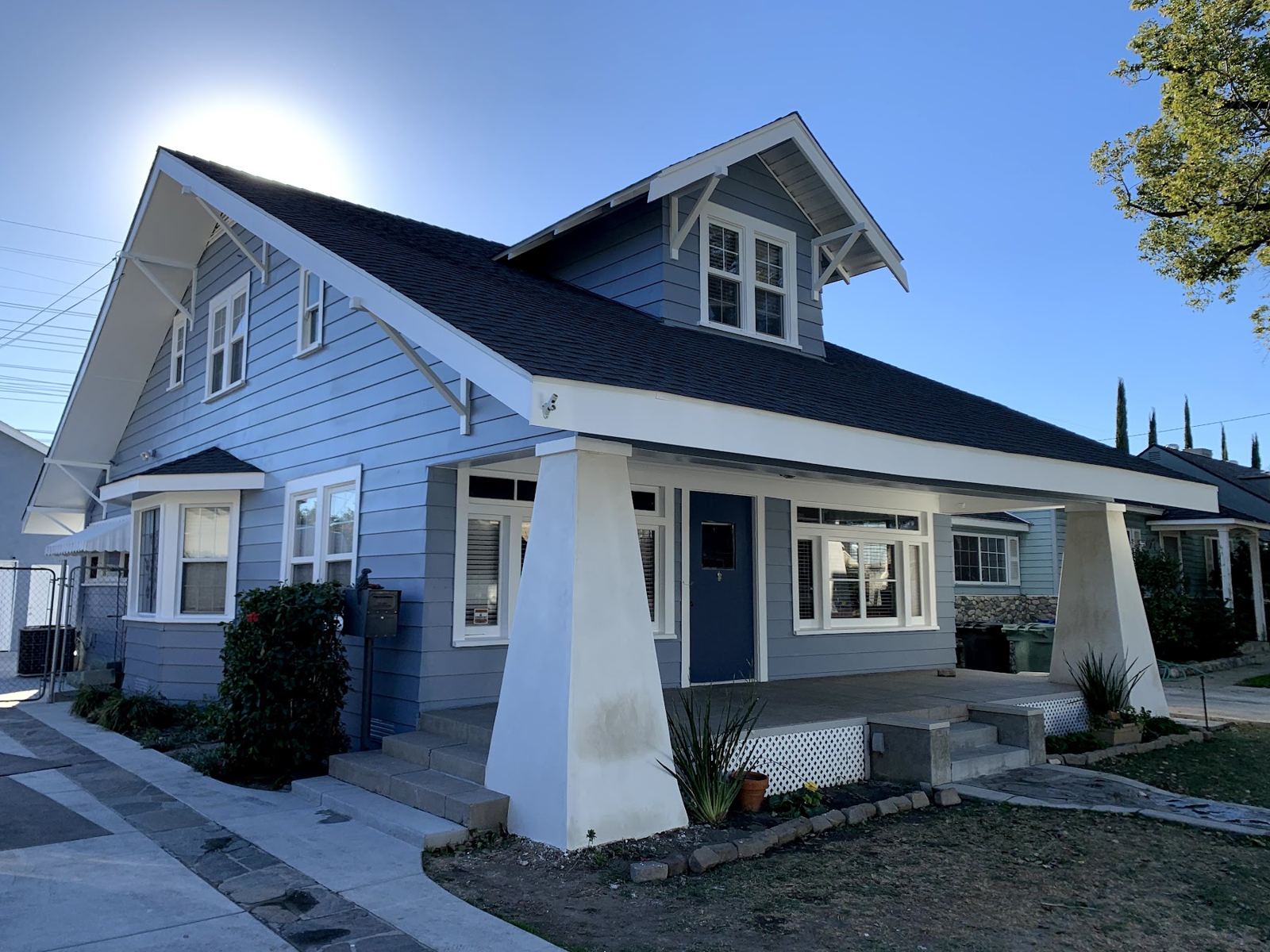 Craftsman bungalow finished in slate blue with white trim