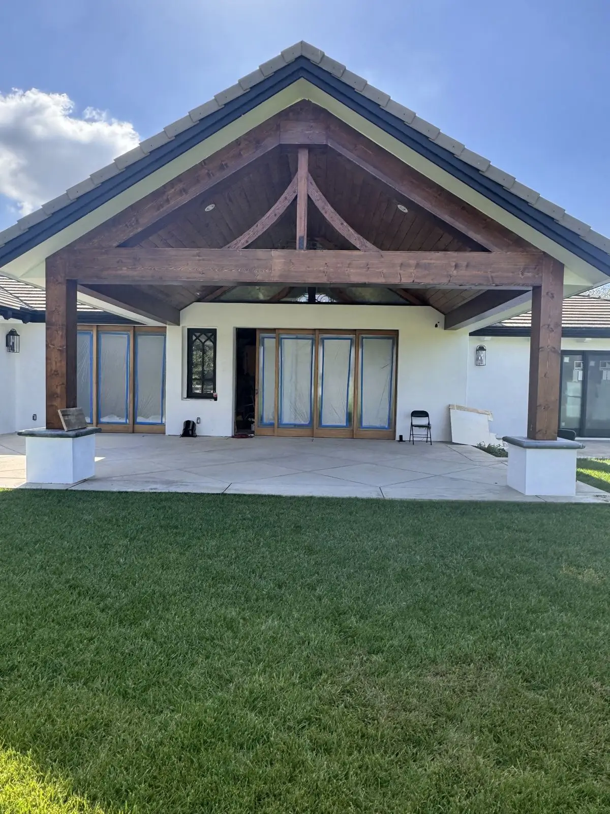 Completed craftsman-style covered patio with stained cedar beams