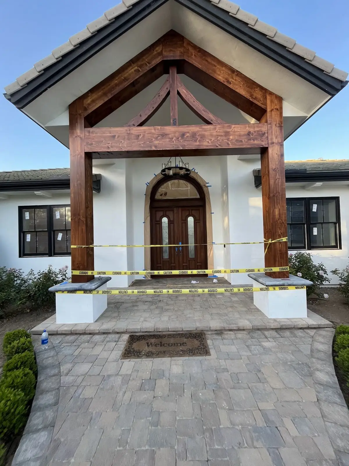 Craftsman entry with stained cedar gable and arched door