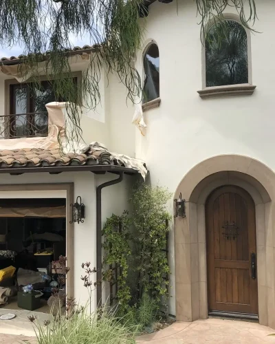 Spanish-style two-story home with fresh white stucco