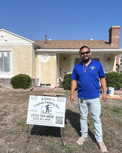 Johnny's Custom Painting on site with a yard sign in front of a finished home
