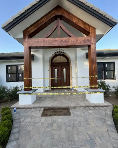 Craftsman entry with stained cedar gable and arched door